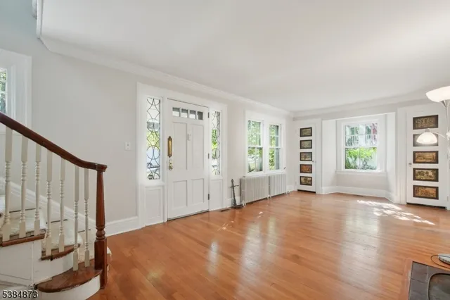 a view of a bedroom with furniture and window