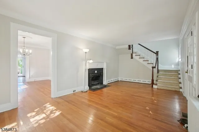 a view of a livingroom with wooden floor and a fireplace