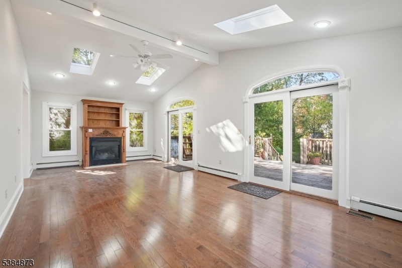 4 Fairwood Road Madison, NJ 07940 - Photo 10 of 38 a view of a livingroom with wooden floor a fireplace and window