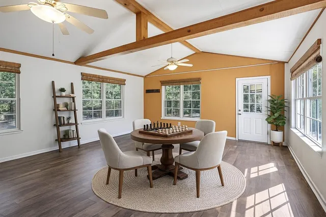 a dining room with furniture a chandelier and wooden floor