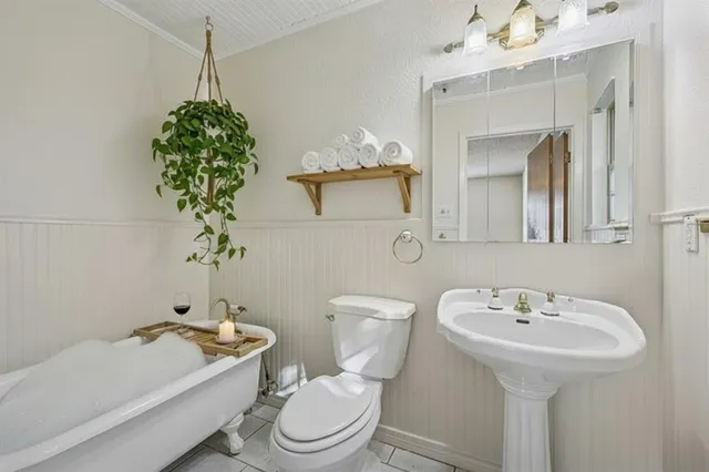 a bathroom with a sink a toilet and bathtub