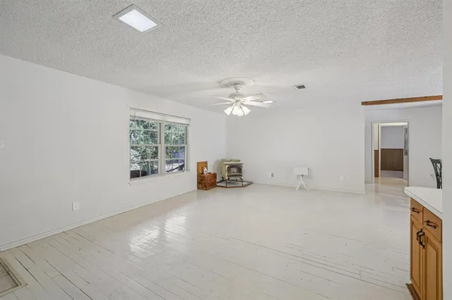 a view of a livingroom with a dishwasher cabinets and a window