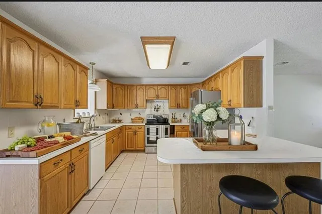 a kitchen with a sink cabinets and window