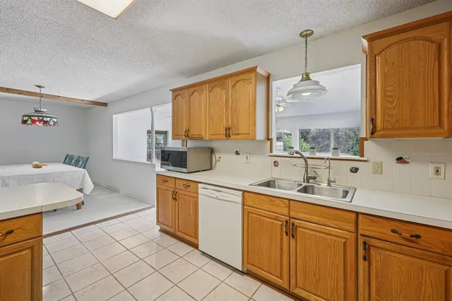 a kitchen with sink cabinets and window