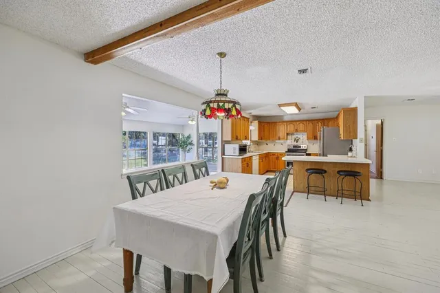 a view of a dining room with furniture and window