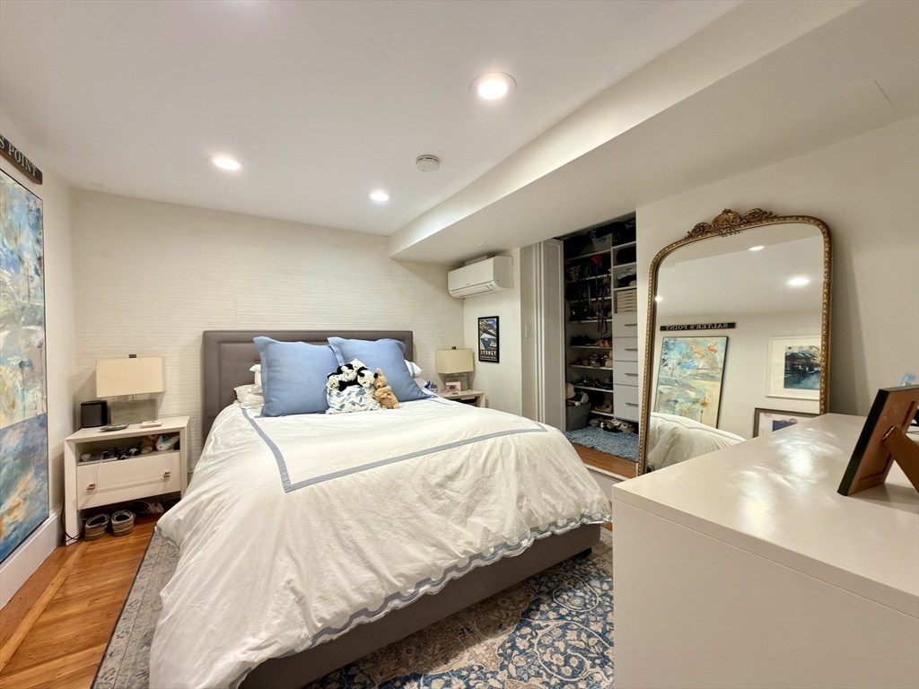 41 Pinckney Street, Unit B Boston, MA 02114 - Photo 10 of 31 a bedroom with a large bed and a large mirror