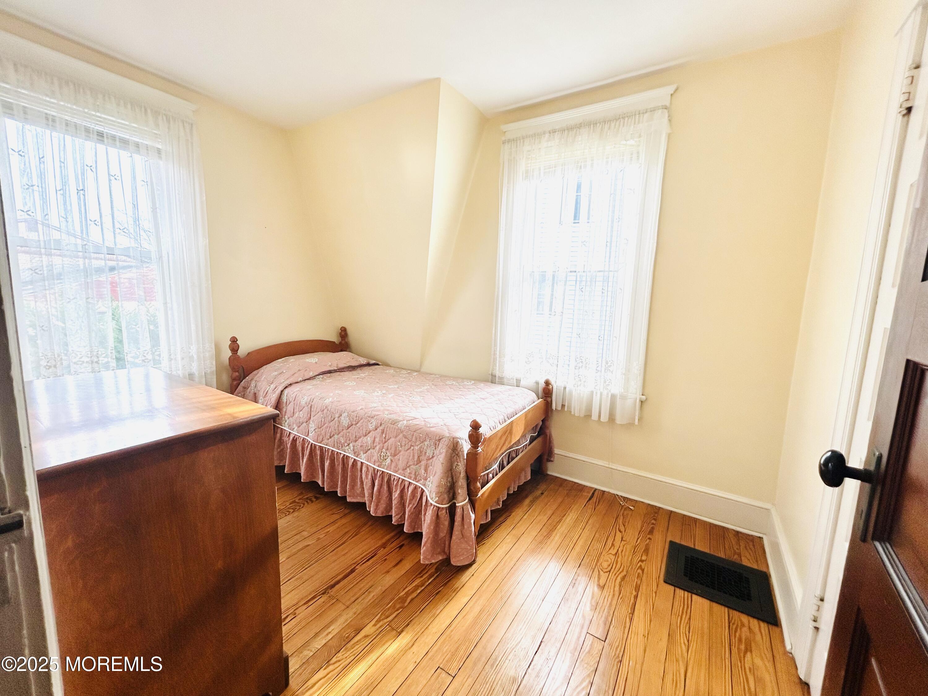 34 Rector Place Red Bank, NJ 07701 - Photo 14 of 34 a bedroom with a bed and a window