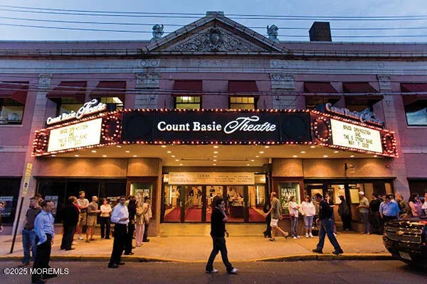 a group of people walking in front of retail shop