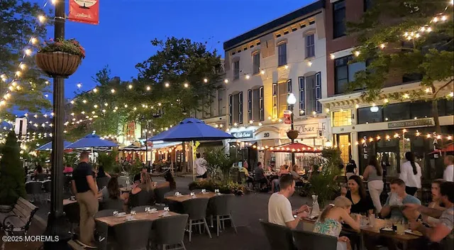 a view of a patio with a table and chairs and potted plants