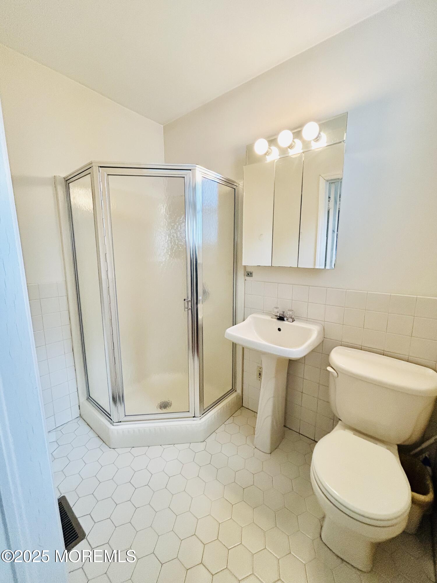 34 Rector Place Red Bank, NJ 07701 - Photo 31 of 34 a bathroom with a toilet sink and a mirror