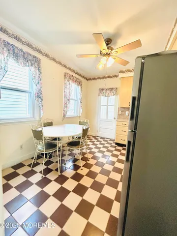 a view of a dining room with a table and chairs