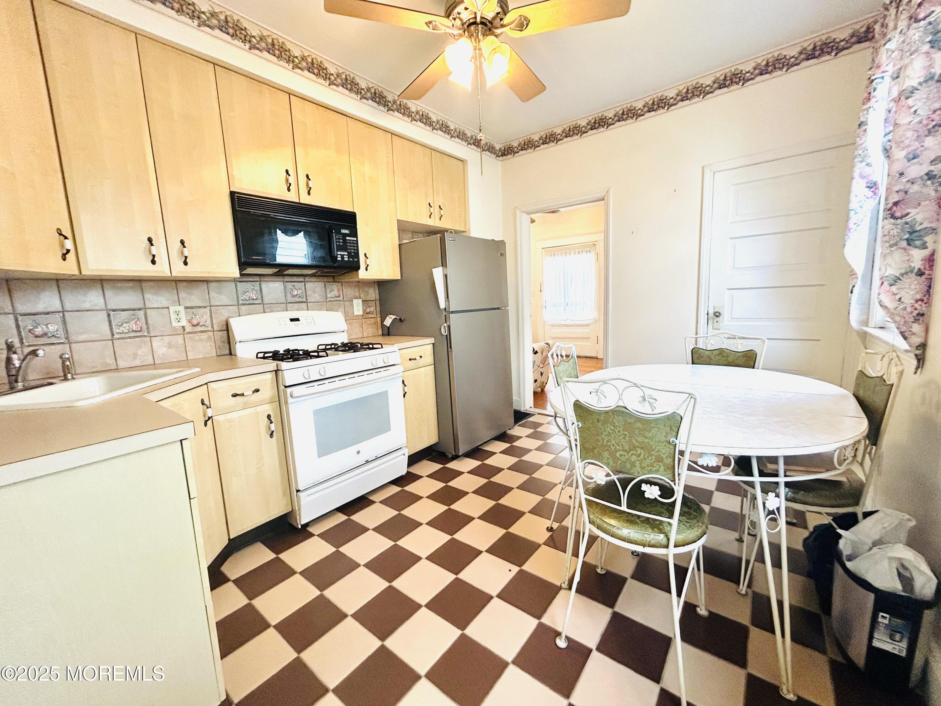 34 Rector Place Red Bank, NJ 07701 - Photo 8 of 34 a kitchen with a sink a stove a table and chairs