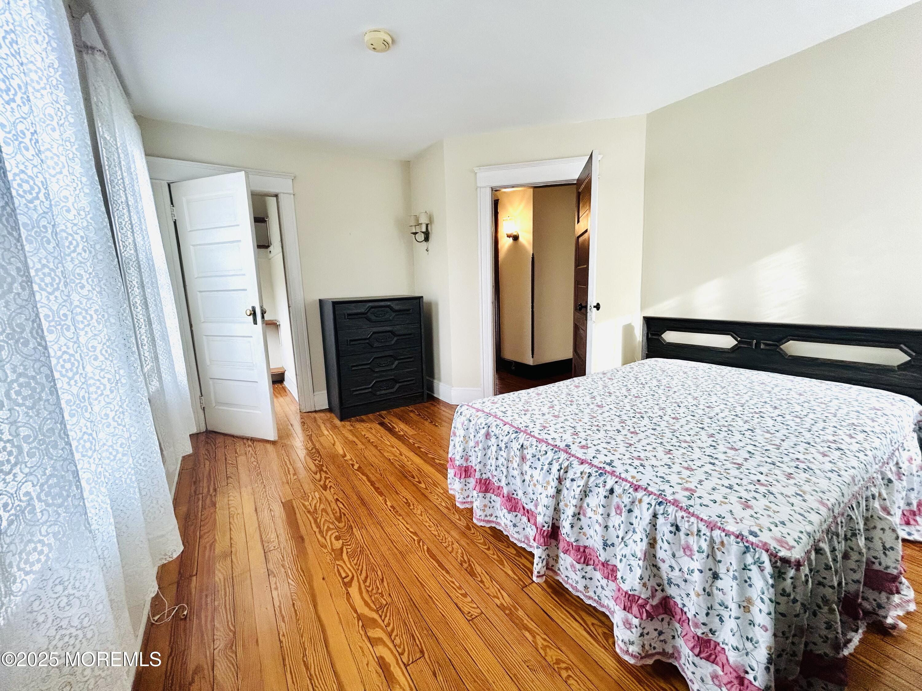 34 Rector Place Red Bank, NJ 07701 - Photo 10 of 34 a bedroom with a bed and wooden floor