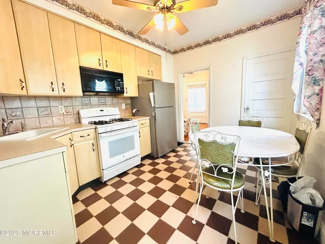 a kitchen with a sink a stove a table and chairs