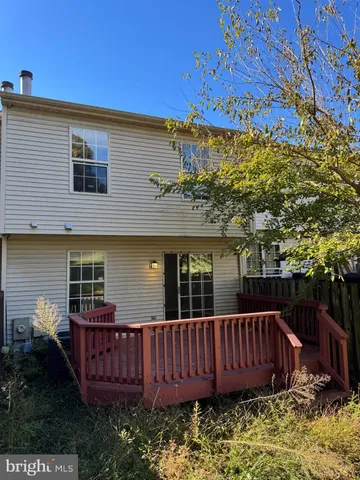 a view of a house with a wooden fence