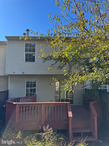 a view of a chair and table in the backyard