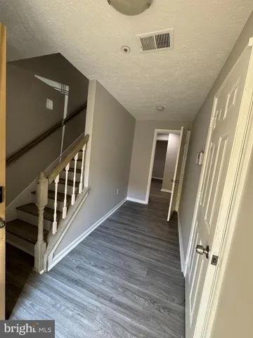 a view of an entryway with wooden floor