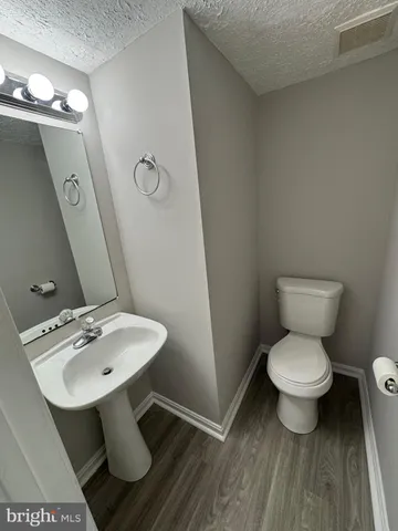 a bathroom with a sink toilet and a mirror