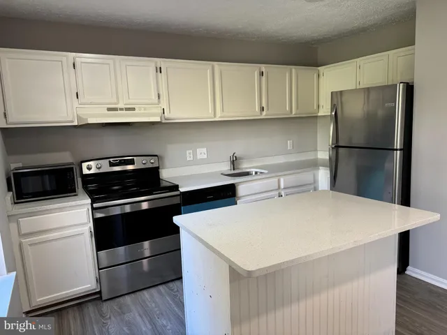 a kitchen with a white cabinets and white appliances