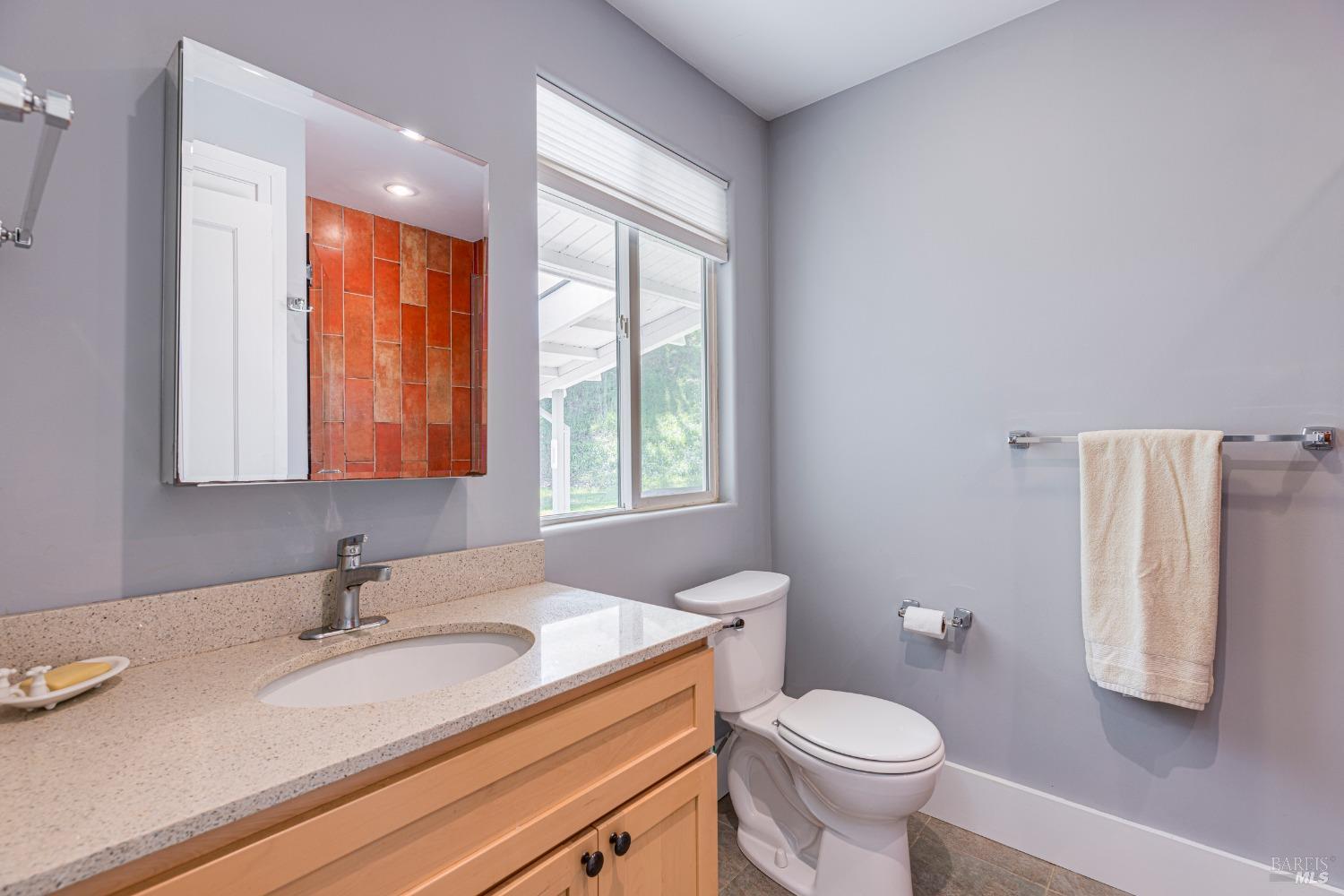 31 Martens Boulevard San Rafael, CA 94901 - Photo 14 of 50 a bathroom with a granite countertop sink toilet and mirror