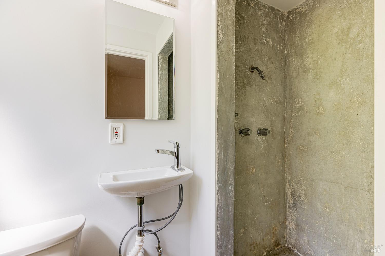 31 Martens Boulevard San Rafael, CA 94901 - Photo 20 of 50 a bathroom with a sink a mirror and a shower