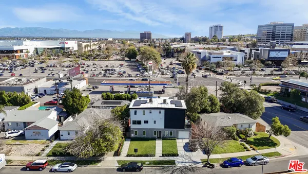 an aerial view of residential houses with outdoor space