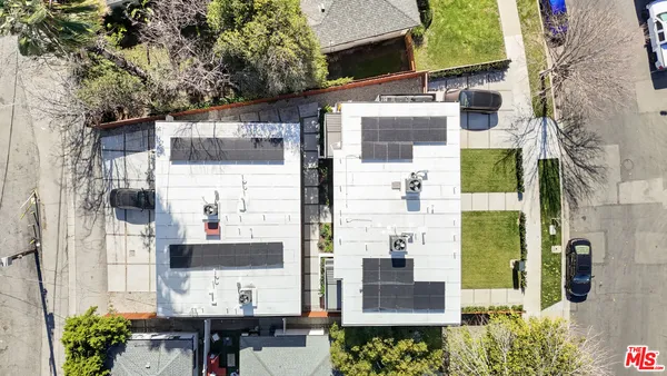 an aerial view of a house with a yard