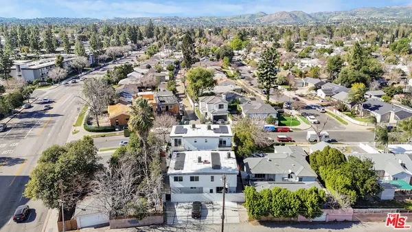 a aerial view of multi story residential apartment building with yard