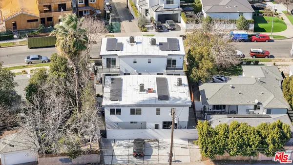 an aerial view of a house with a yard and fountain in middle