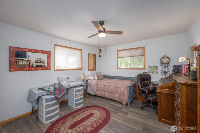 a bedroom with two beds and a dresser