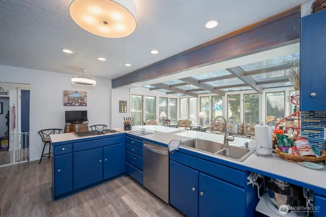 a large kitchen with lots of counter space and a sink