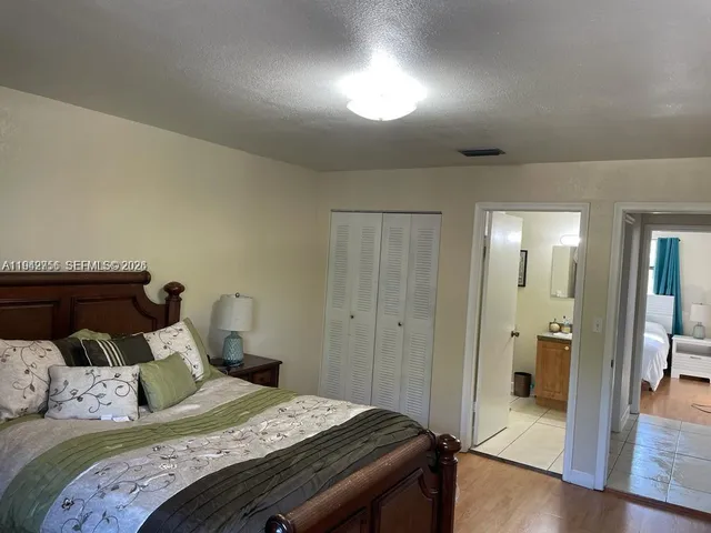 a bedroom with a bed and a mirror