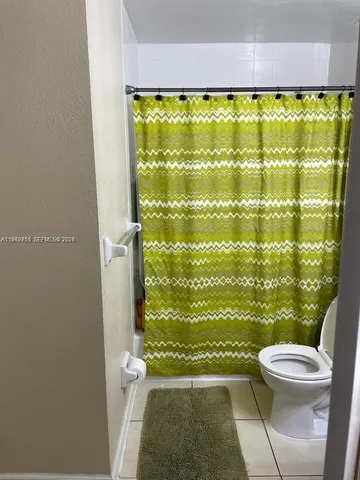 a bathroom with sink toilet and shower