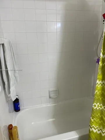 a bathroom with a tub and a shower