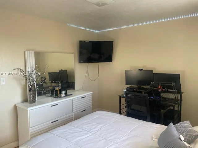 a room with a bed and a flat screen tv
