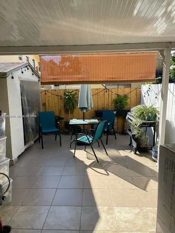 a living room with furniture a window and a flat screen tv