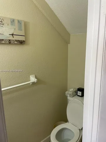 a white toilet sitting next to a shower