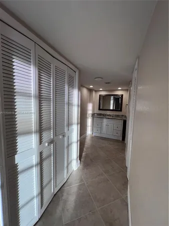 a view of a electric appliances in kitchen and an empty room