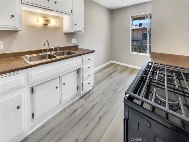 a kitchen with granite countertop a stove and a sink