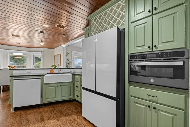 a kitchen with stainless steel appliances granite countertop a refrigerator and a sink