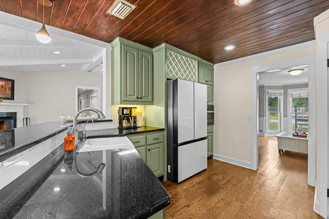 a kitchen with stainless steel appliances granite countertop a refrigerator and a sink