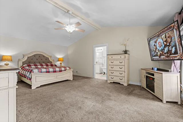 a bedroom with a bed and a tv