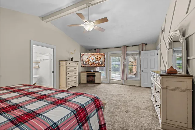 a spacious bedroom with a bed and a chandelier