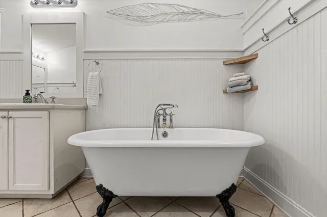 a white bath tub sitting next to a white sink