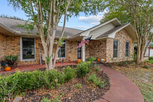 a front view of a house with garden