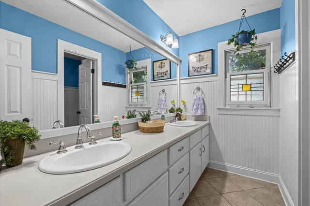 a bathroom with a sink double vanity and a mirror