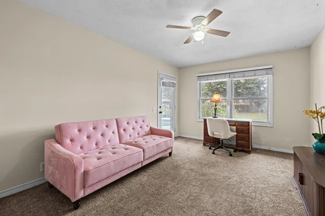 a living room with furniture and a large window