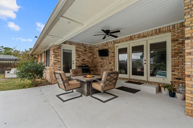 a view of a patio with table and chairs and potted plants
