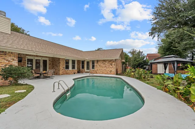 a view of a house with swimming pool and porch