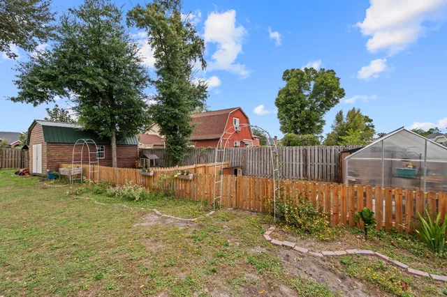 a backyard of a house with wooden fence
